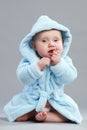 Adorable baby boy in a blue bathrobe Royalty Free Stock Photo