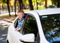 Adorable baby boy in the car. Laughing boy looks out of the car window. Royalty Free Stock Photo