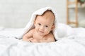 Adorable baby boy crawling on bed and hiding under blanket Royalty Free Stock Photo