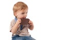 Adorable baby boy eating chocolate. Royalty Free Stock Photo