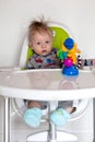 Adorable baby boy in a highchair