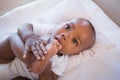 Adorable baby boy lying in his crib holding foot Royalty Free Stock Photo