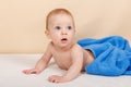 Adorable baby boy lying under the towel and having fun after bath Royalty Free Stock Photo