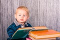 Adorable baby boy with a pile of books Royalty Free Stock Photo