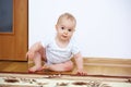 Adorable baby boy playing in badroom in sunny day