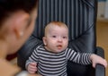 Adorable Baby on Chair Eating Porridge Food Royalty Free Stock Photo