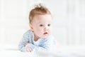 Adorable baby doing her tummy time in a white nursery Royalty Free Stock Photo