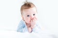 Adorable baby doing her tummy time in a white nursery Royalty Free Stock Photo