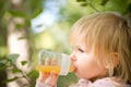 Adorable baby drinking juice with bottle Royalty Free Stock Photo