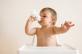 Adorable baby drinking milk from a bottle from bottle. Formula drink for infant. Kitchen Royalty Free Stock Photo