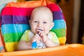 Adorable baby eating in high chair Royalty Free Stock Photo