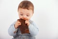 Adorable baby eating a plate of chocolate Royalty Free Stock Photo