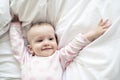 Adorable baby girl cover with white sheet wearing pink clothes Royalty Free Stock Photo