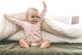 Adorable baby girl cover with white sheet wearing pink clothes Royalty Free Stock Photo