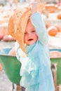 Adorable Baby Girl with Cowboy Hat in a Country Rustic Setting at the Pumpkin Patch Royalty Free Stock Photo