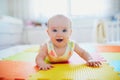 Smiling baby girl lying on play mat Royalty Free Stock Photo