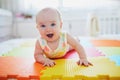 Smiling baby girl lying on play mat Royalty Free Stock Photo