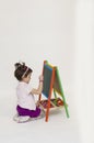 Adorable baby girl drawing on black board Royalty Free Stock Photo