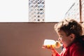 Adorable baby girl drinking milk from her bottle isolated outdoors Royalty Free Stock Photo