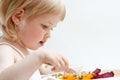 Adorable baby girl eating fresh vegetables Royalty Free Stock Photo