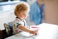 Adorable baby girl eating from spoon fresh healthy raspberries food, child, feeding and development concept. Cute Royalty Free Stock Photo