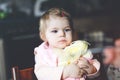 Adorable baby girl eating from spoon mashed vegetables and puree. food, child, feeding and people concept -cute toddler Royalty Free Stock Photo