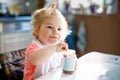 Adorable baby girl eating from spoon vegetables or fruit canned food, child, feeding and development concept. Cute Royalty Free Stock Photo