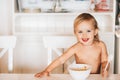 Adorable baby girl with good appetite eats pasta