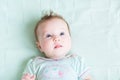 Adorable baby girl on a green knitted blanket smiling Royalty Free Stock Photo