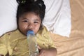 Adorable baby girl holding milk bottle and drinking Royalty Free Stock Photo