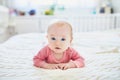 Baby girl lying on bed and smiling Royalty Free Stock Photo