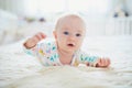 Baby girl lying on bed and smiling Royalty Free Stock Photo