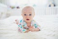 Baby girl lying on bed and smiling Royalty Free Stock Photo