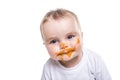 Adorable baby girl making a mess while feeding