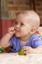 Adorable baby girl 5 months old sucking finger smiling Royalty Free Stock Photo