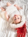 Adorable baby girl in Santa hat lying on the bed Royalty Free Stock Photo