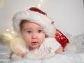 Adorable baby girl in Santa hat lying on the bed Royalty Free Stock Photo