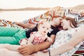 Adorable baby girl  shocked face, lying with her happy father and mother, young hipster couple relaxing with daughter in  a Royalty Free Stock Photo