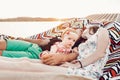 Adorable baby girl  shocked face, lying with her happy father and mother, young hipster couple relaxing with daughter in  a Royalty Free Stock Photo