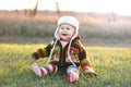 Adorable Baby Girl in Winter Hat and Sweater Laughing Outside Royalty Free Stock Photo