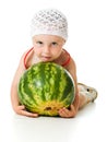 An adorable baby happily plays the watermelon