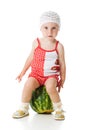 An adorable baby happily plays the watermelon