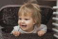 Adorable baby hiding in a laundry basket