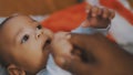 Adorable baby holding father hand. Mulatto baby playing with fathers hand. close up Royalty Free Stock Photo