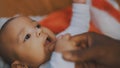 Adorable baby holding father hand. Mulatto baby playing with fathers hand. close up Royalty Free Stock Photo