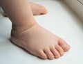 Adorable baby little feet stand, first steps, close-up Royalty Free Stock Photo