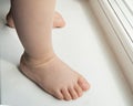 Adorable baby little feet stand, first steps, close-up Royalty Free Stock Photo