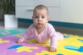 Adorable Baby lying on child friendly floor puzzle Royalty Free Stock Photo