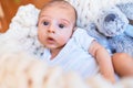 Adorable baby lying down over blanket on the floor at home Royalty Free Stock Photo