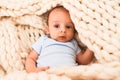 Adorable baby lying down over blanket on the sofa at home Royalty Free Stock Photo